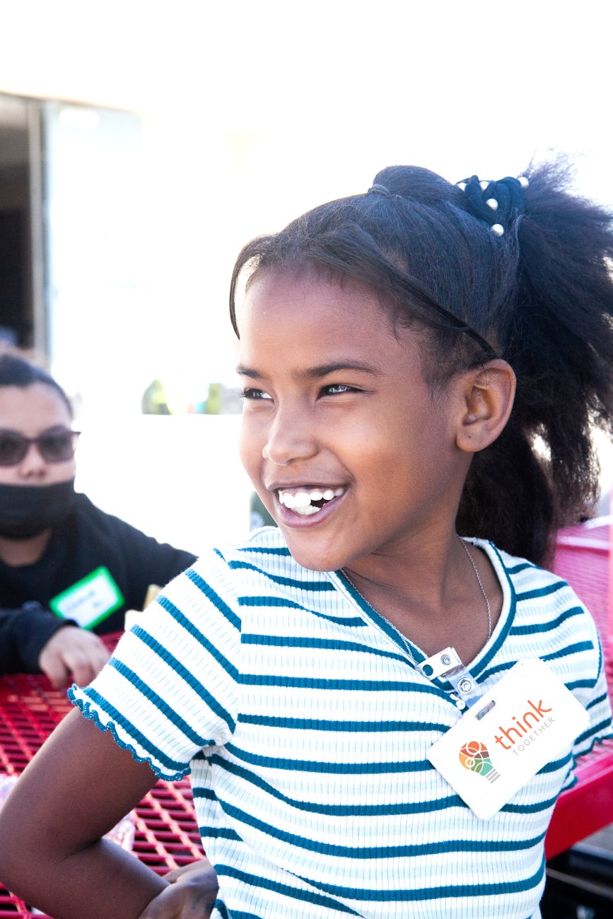 girl wearing think together tag